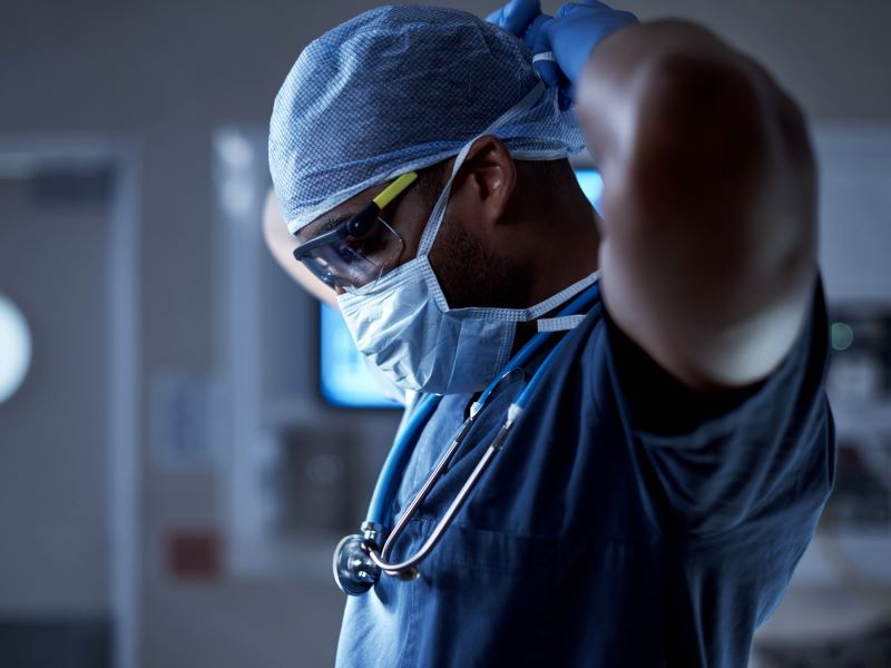 Healthcare worker putting on medical mask