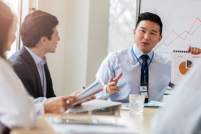 a healthcare finance team meeting in a conference room