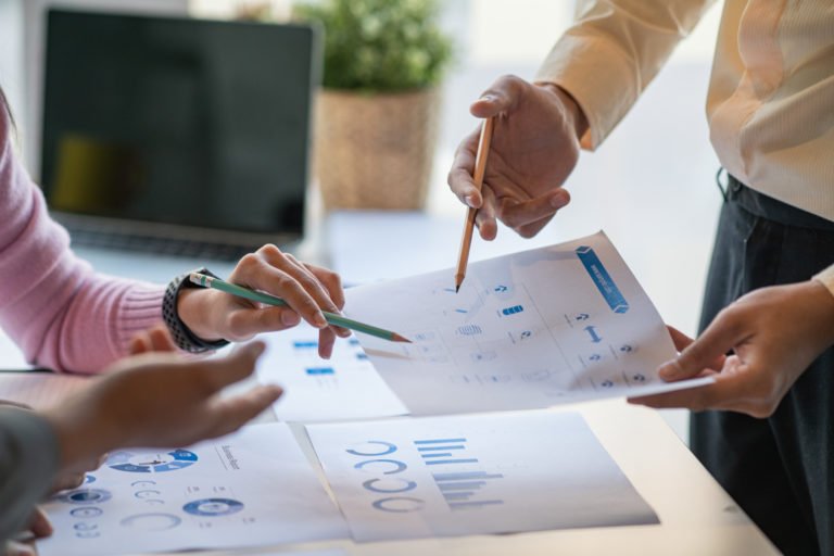 executives at a healthcare facility reviewing capital capacity reports