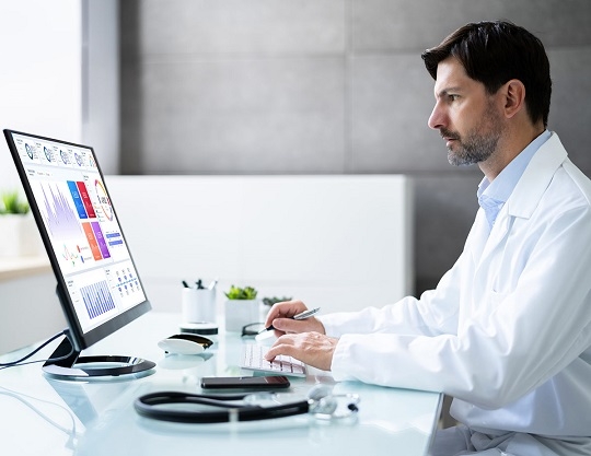 HC man analyzing physician data on desktop  man analyzing physician data on desktop